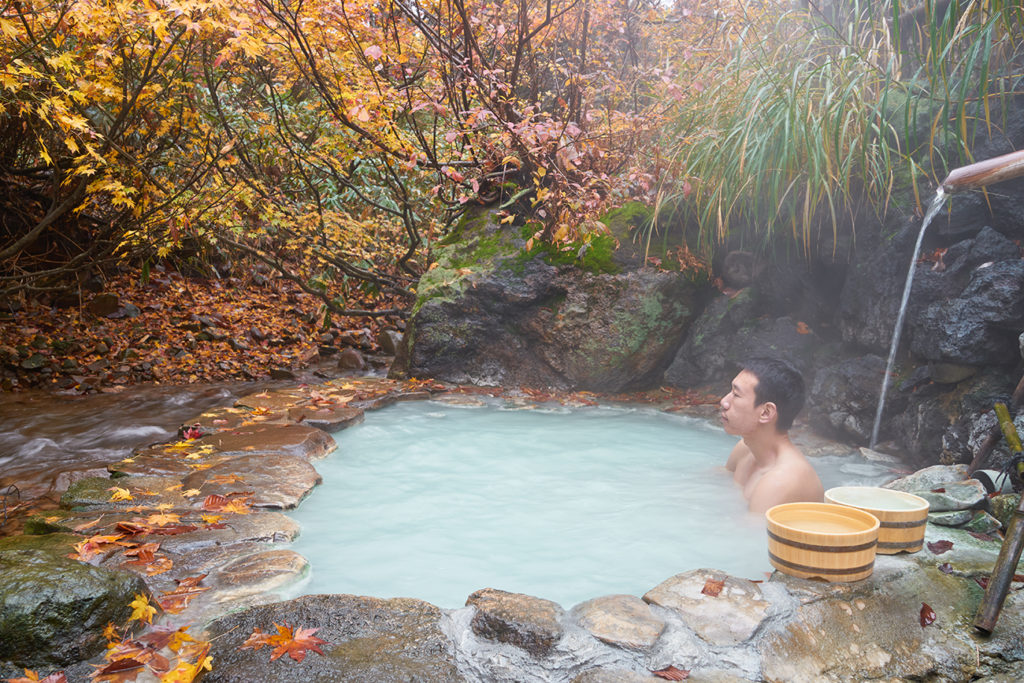 Man in bathing in an onsen